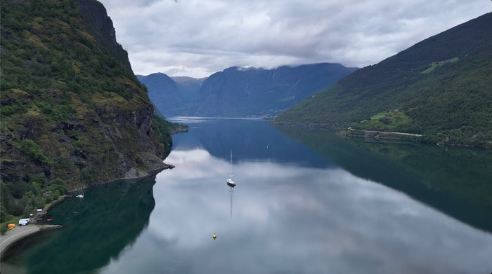 fjord of Norway with a boat in the still water