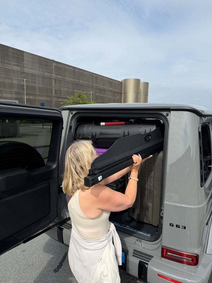 woman loading luggage into car